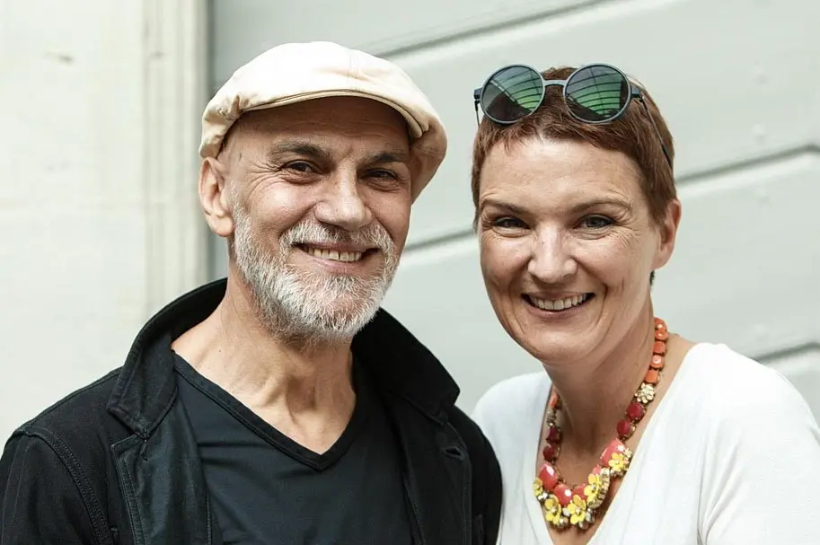 Owners of Brady’s Irish Bar, smiling together outside the bar