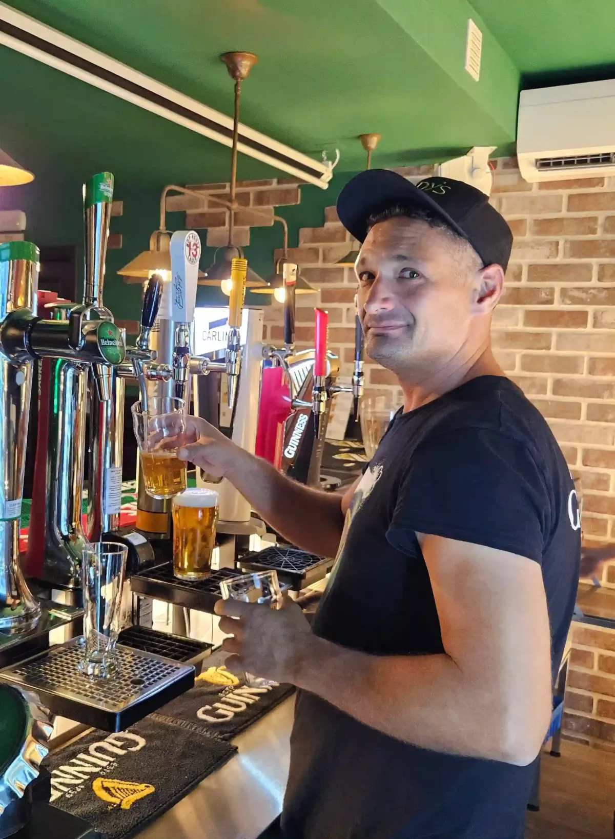 Bartender pouring beer at the tap inside Brady’s Irish Bar