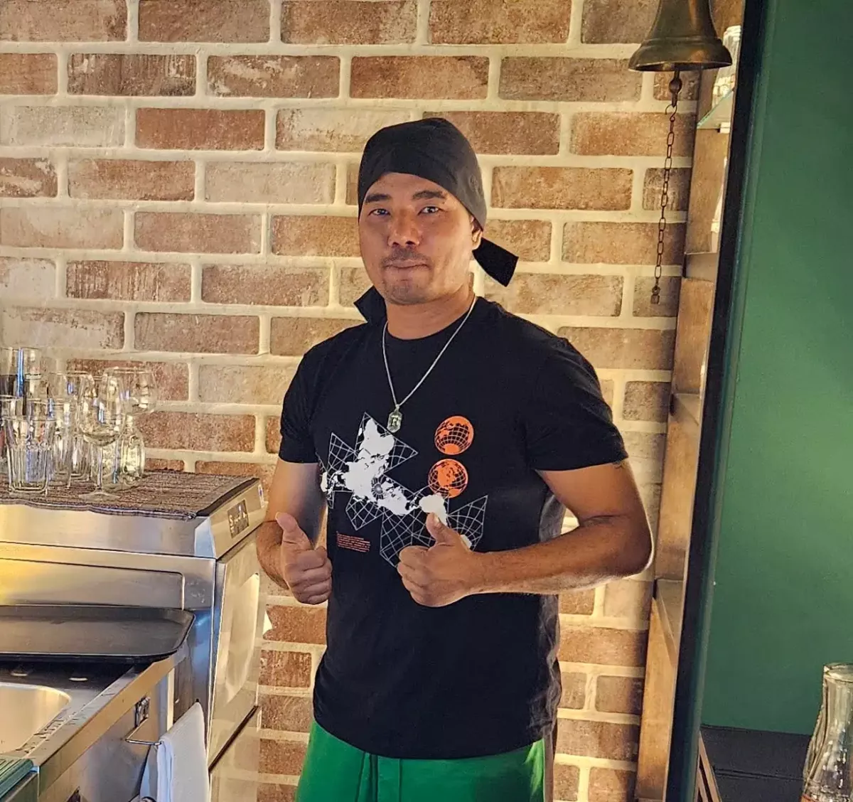 Smiling staff member giving thumbs up inside Brady’s Irish Bar