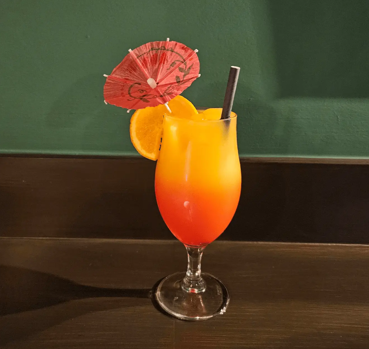 Orange and red layered cocktail served in a tropical glass at Brady’s Irish Bar in Carvoeiro